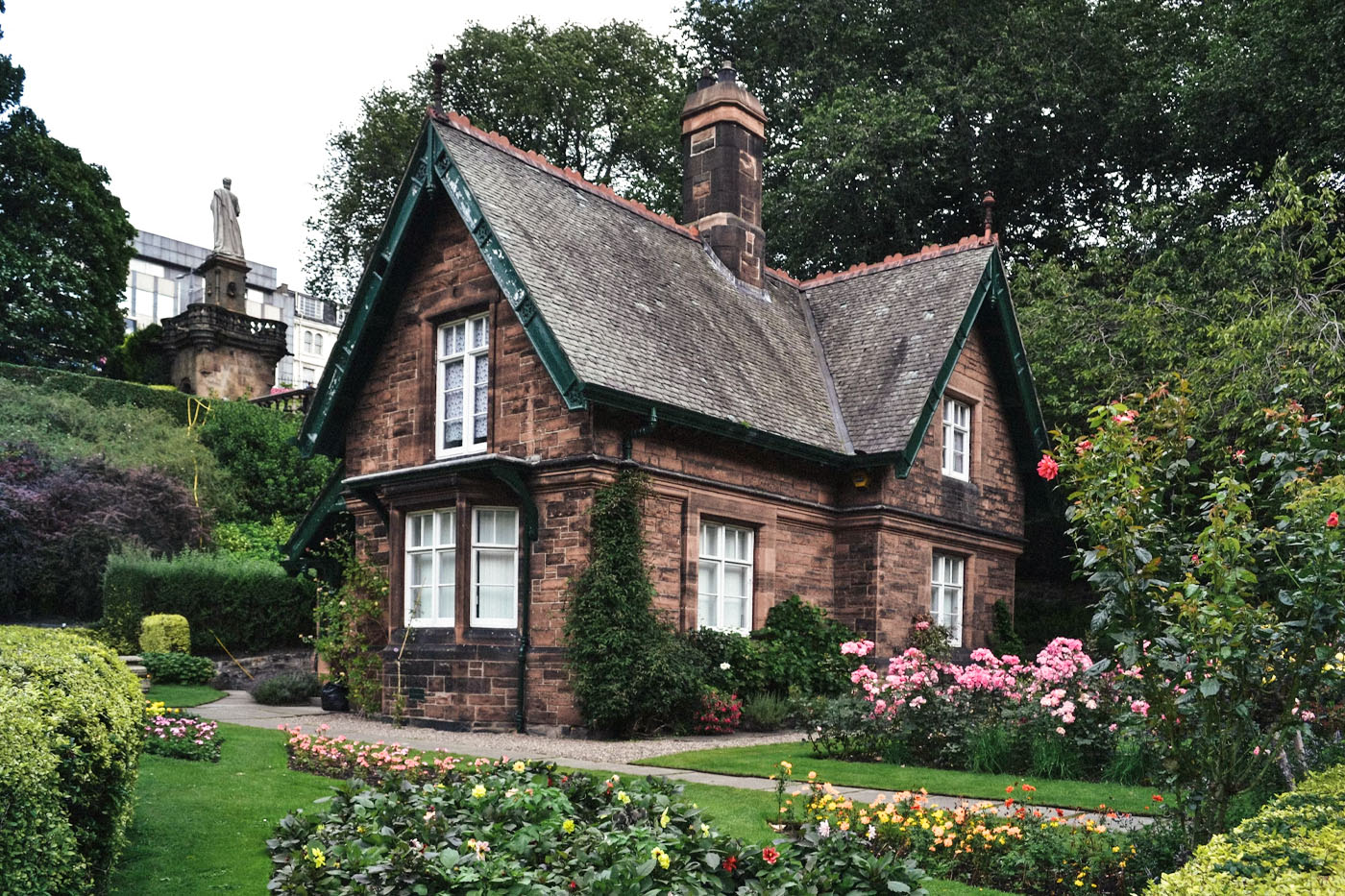 house surrounded by flowers and trees