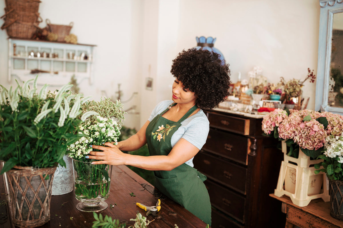 Woman caring for her plants inside her house