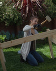 A woman assembling an Ecogardener Elevated Raised Bed