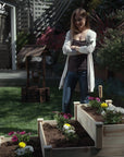 A woman looking at Ecogardener Tiered Raised Bed