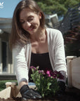 A woman planting on Ecogardener Tiered Raised Bed