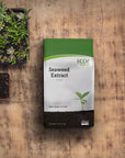 EcoGardener Seaweed Extract in the table with potted flowers