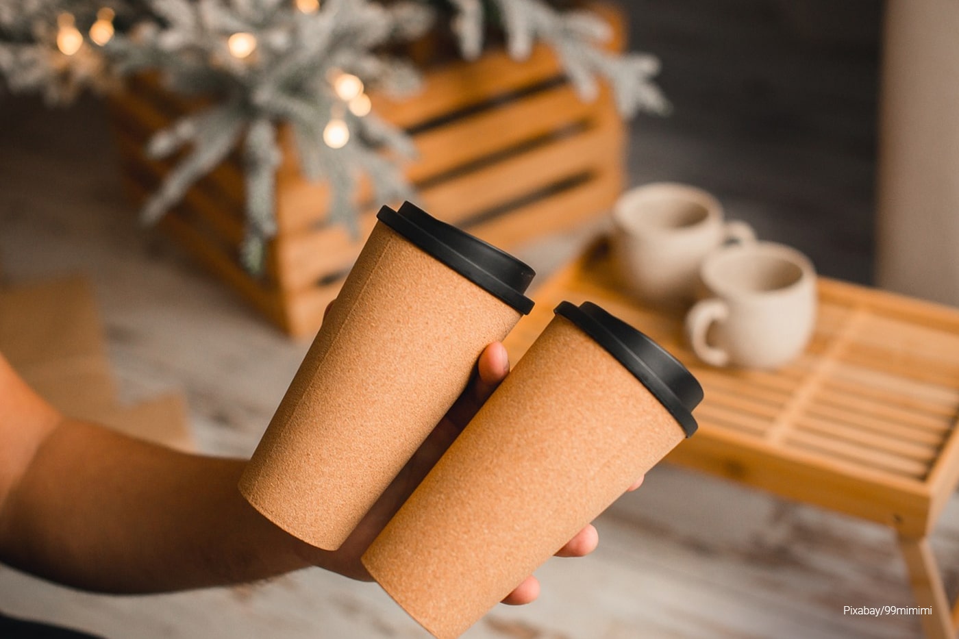 man holding disposable cups