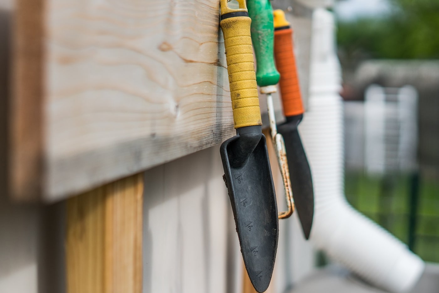 shovels hanged in a wooden board 