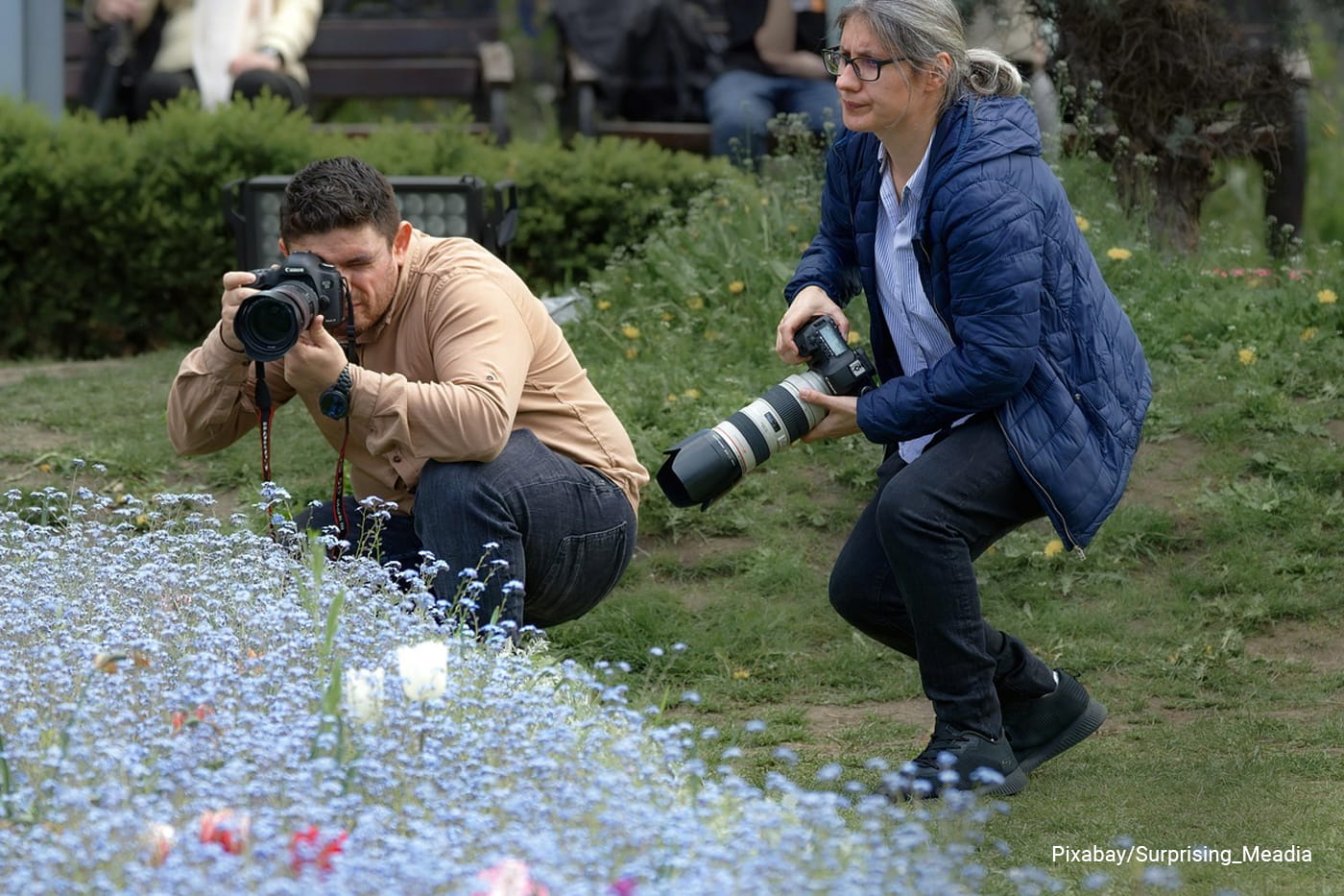 two adults capturing plants
