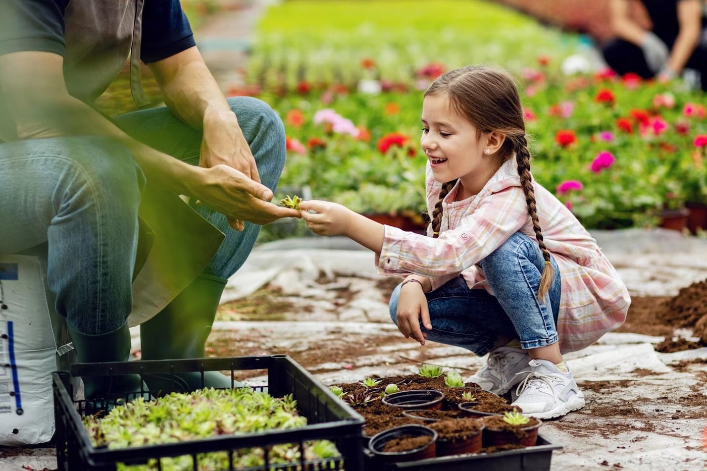 a kid enjoying gardening with her grand father
