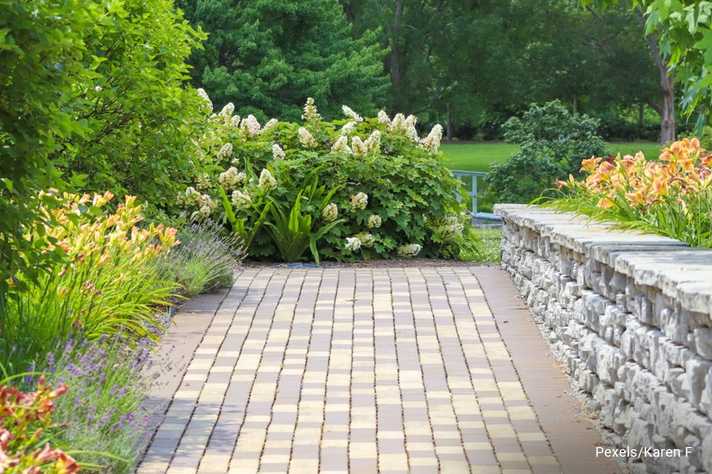 A serene garden path with vibrant flowers and lush greenery