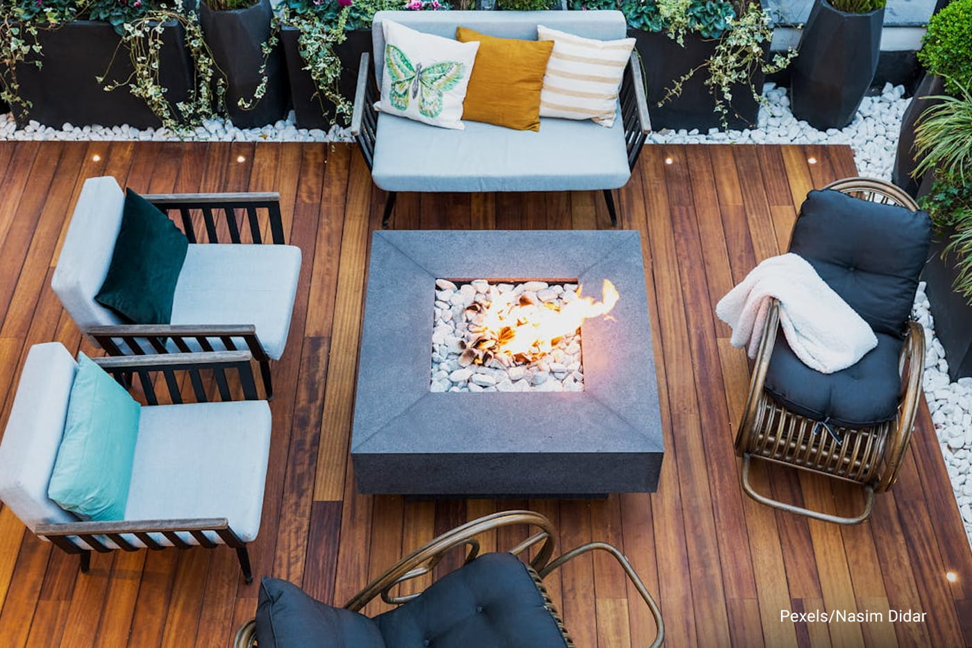deck with center square table with bon fire surrounded with chairs