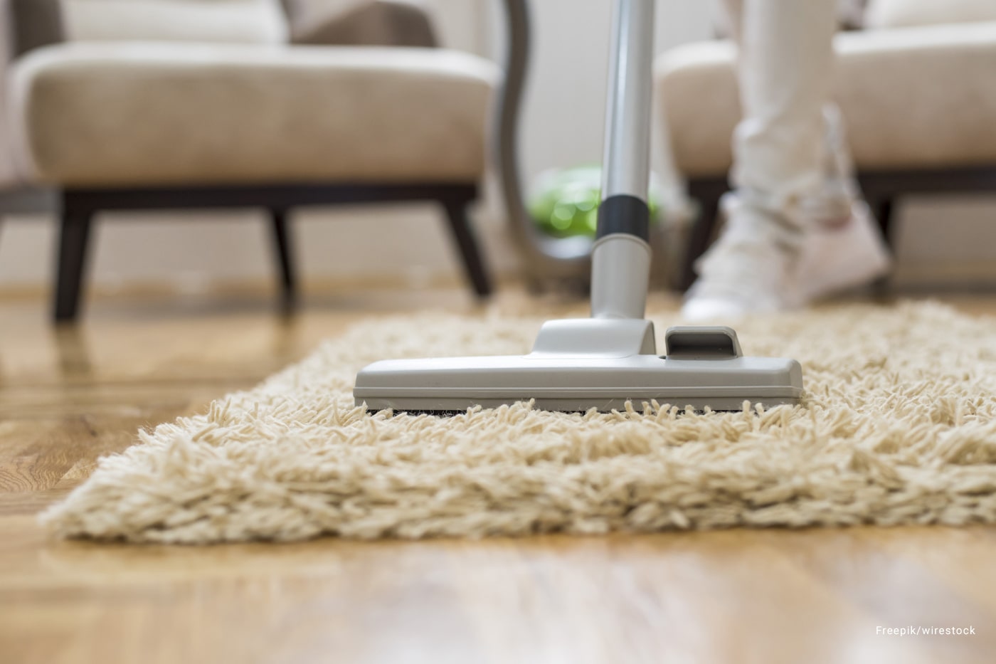 A person cleaning a rug