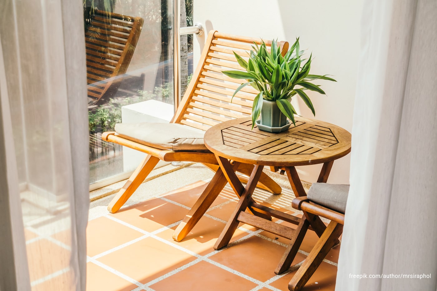 A patio with chair and a coffee table