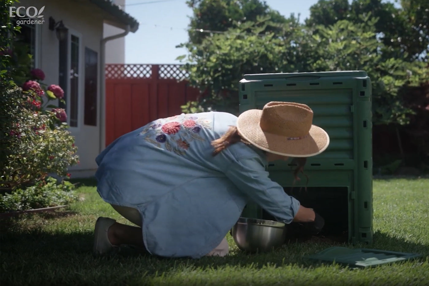 A woman taking compost from a compost bin