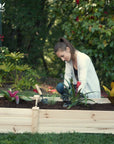 A woman planting in an Ecogardener Raised Bed.